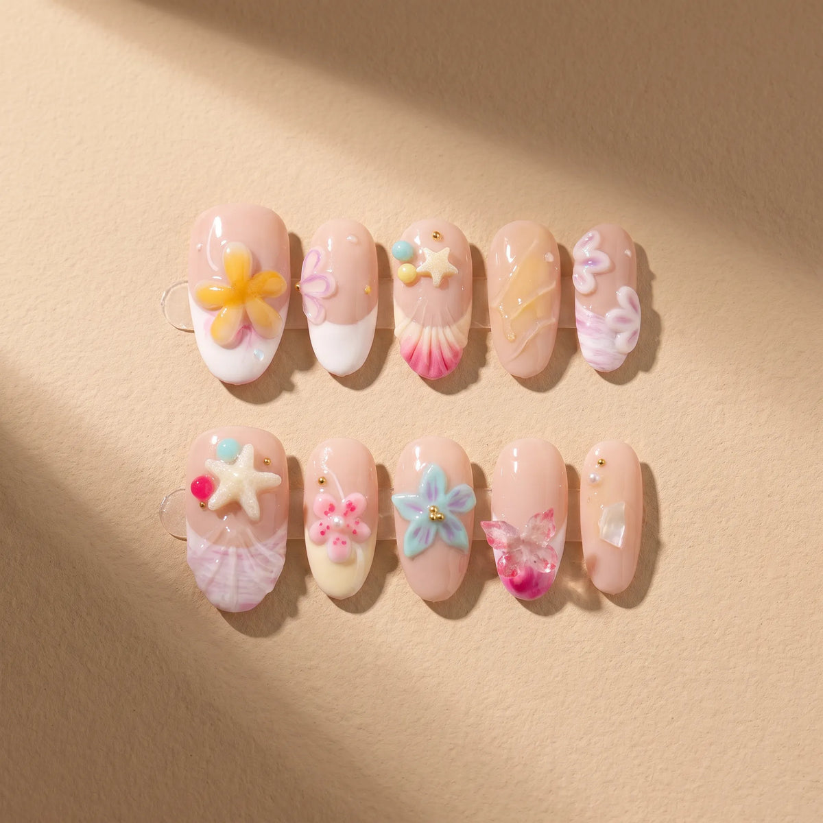 Ocean Shell 10-piece handmade press-on nail set with 3D seashell and starfish designs - product flat lay 🐚