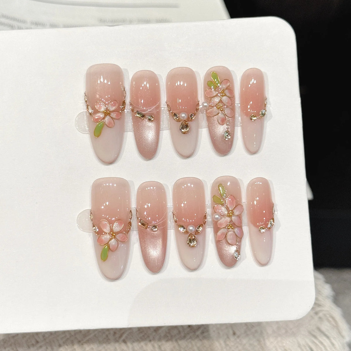 Peach Gold medium stiletto press-on nails with nude pink gold branch rhinestone luxe design on hand - lifestyle shot 🍑✨
