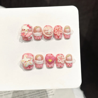 Pink Star Kitty short square press-on nails with 3D cat and bow kawaii design on hand - lifestyle shot