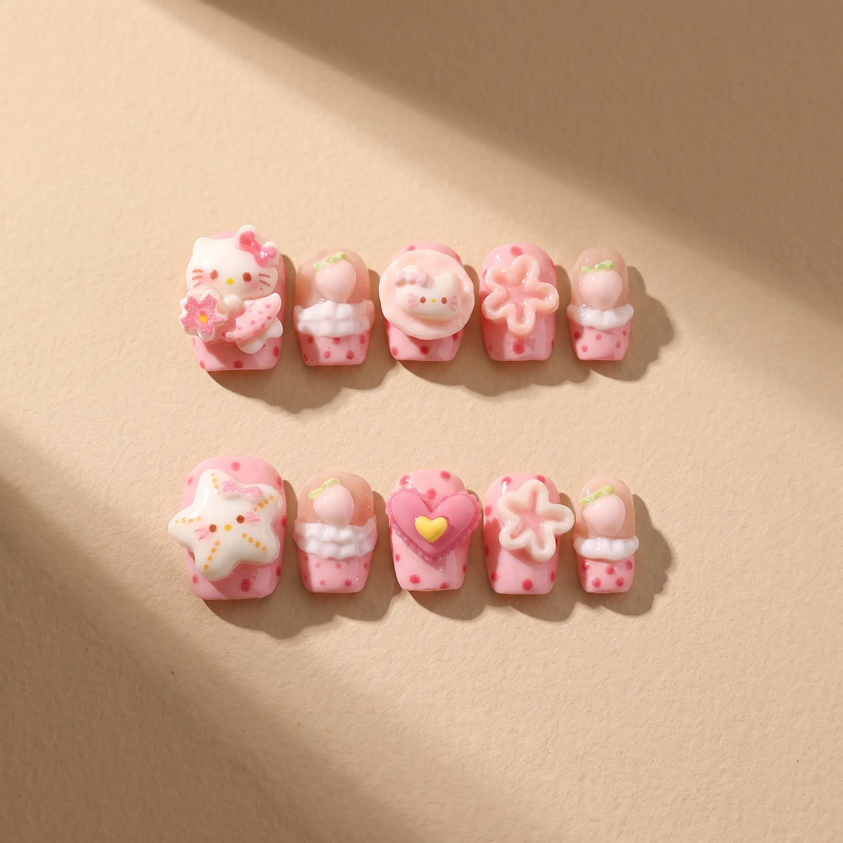 Pink Star Kitty 10-piece handmade press-on nail set with 3D cat and kawaii designs - product flat lay