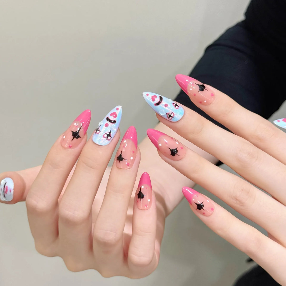 Playful clown medium almond press-on nails 3034 shown in a lifestyle hand view