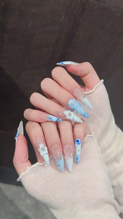 Porcelain Tide press-on nails with blue gradient floral and water ripple designs - 360 degree product video showcase