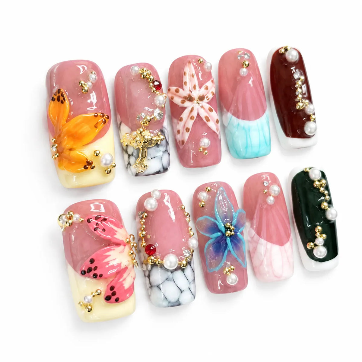 Angled view of rose pink Medium Coffin nails with sculpted florals colorful French tips and gold beads
