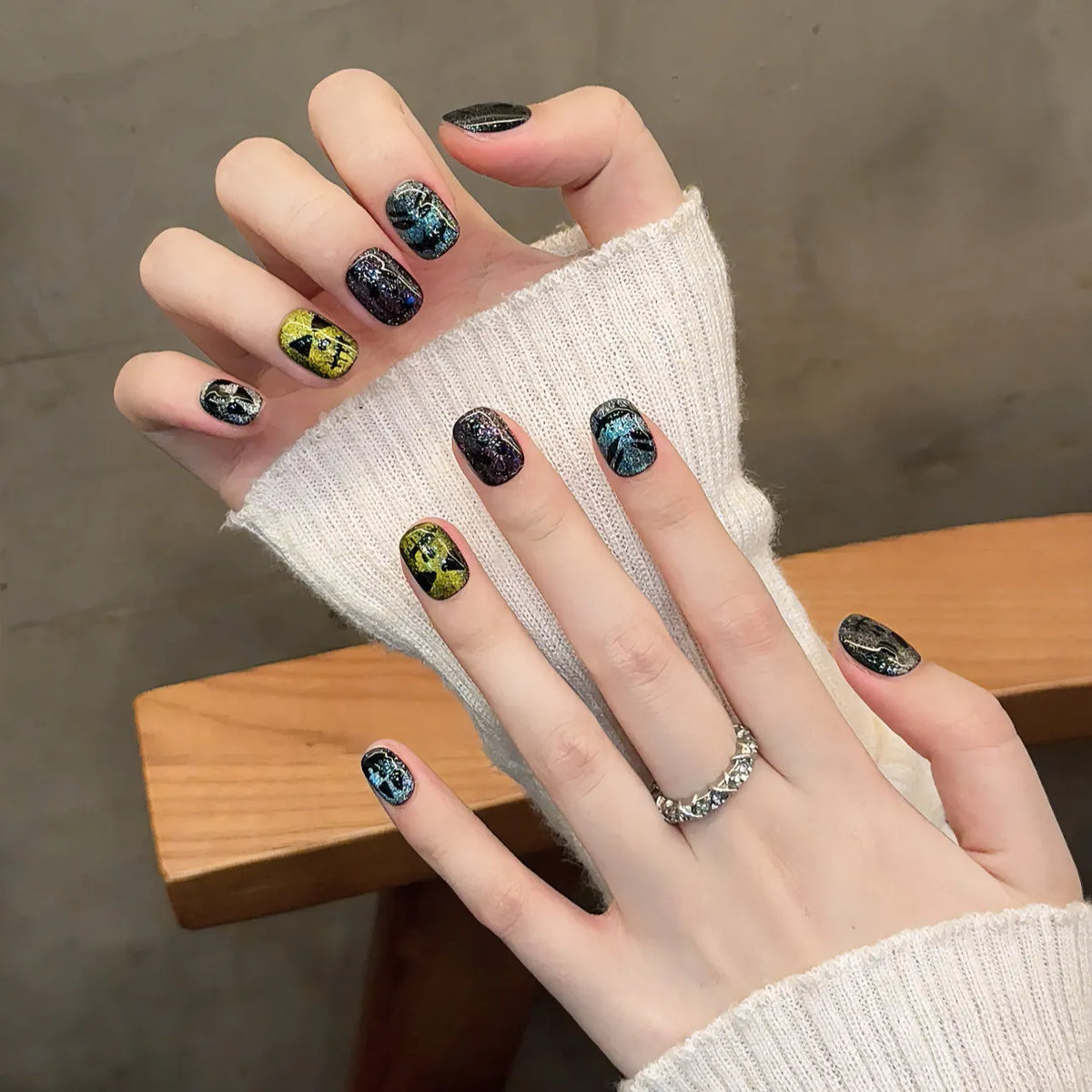 Rainbow cat-eye little-devil short oval press-on nails 2054 shown in a hand lifestyle view