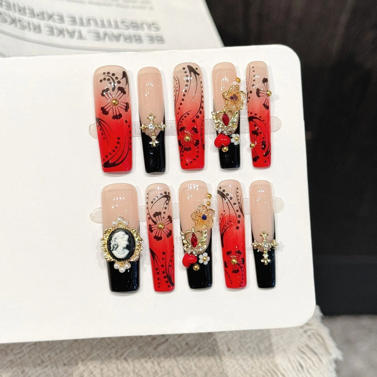 Red Ink Floral long square press-on nails with vintage red black gradient hand-painted design on hand - lifestyle shot 🌹🖤