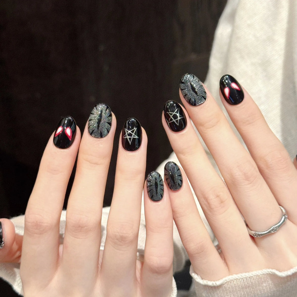 Red Spider Night stiletto nails angled view showing red and black base, spider motifs, and chain decorations 🕸️