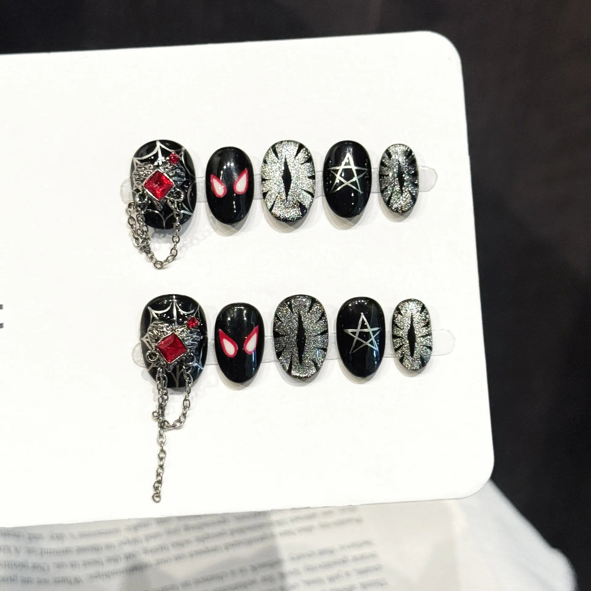 Red Spider Night long stiletto press-on nails with spider web, chains, and glitter gothic design on hand - lifestyle shot 🕷️⛓️