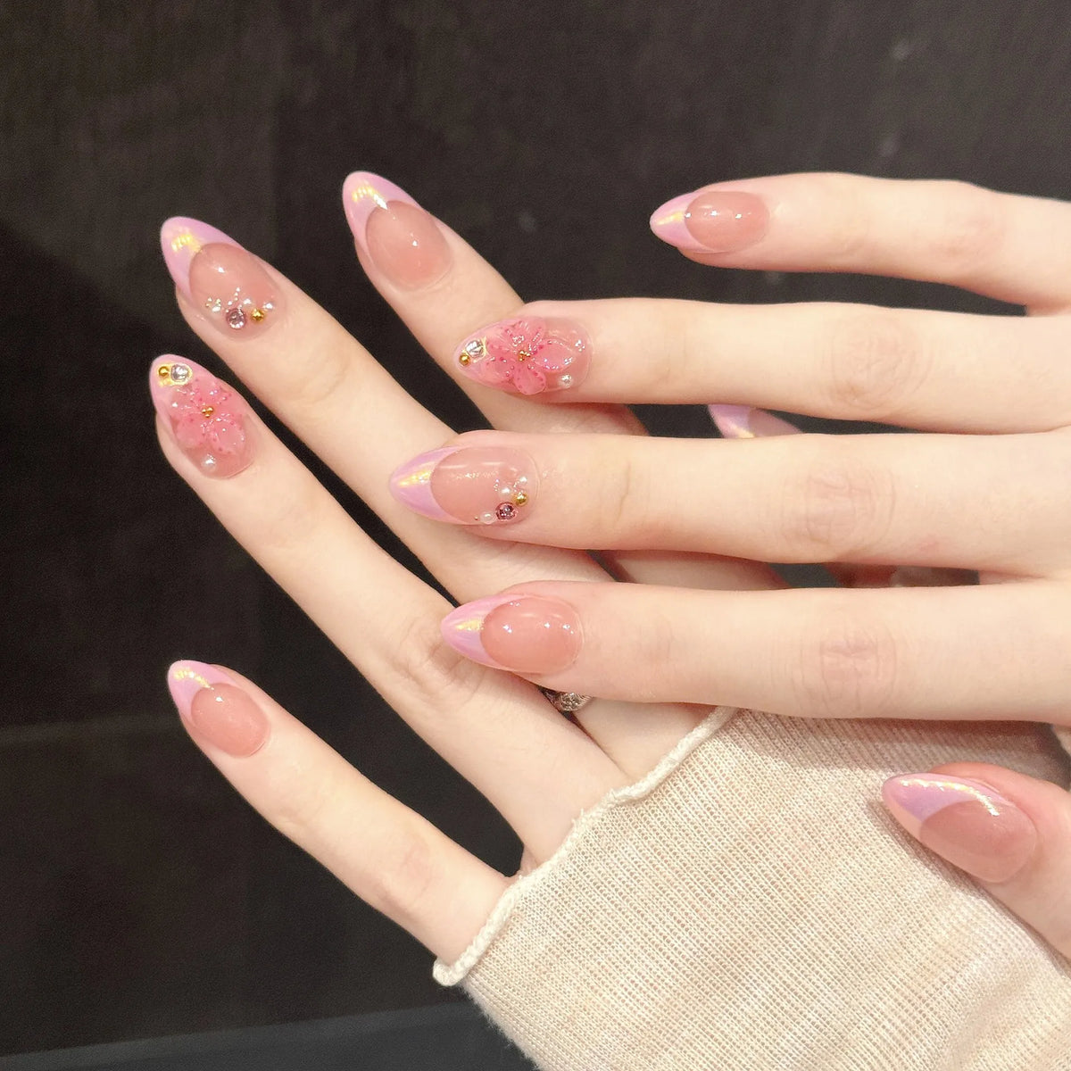 Close-up detail of Rose Quartz Glow chrome mirror finish, pink French tips, and iridescent aurora glow