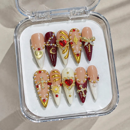 Sacred Garnet Heart handmade Long Stiletto nail set arranged in a clear presentation case