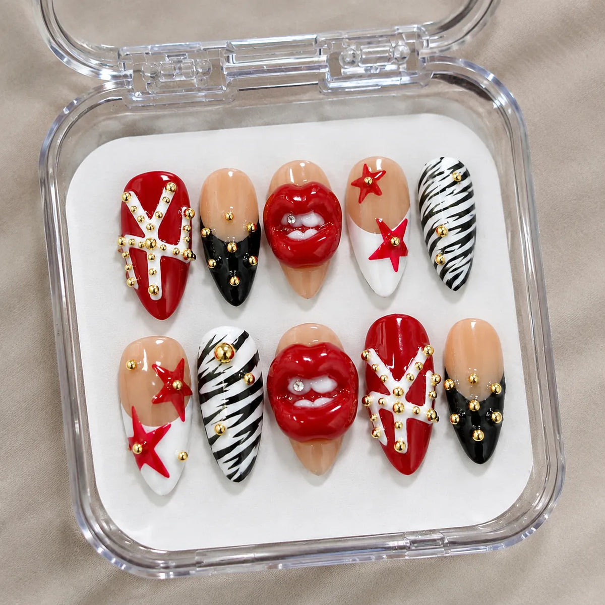 Scarlet Kiss Rebel handmade Medium Almond nail set arranged in a clear presentation case