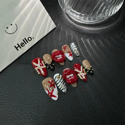 Lifestyle display of NM-C090 Medium Almond nails with dimensional red lips zebra print and stars
