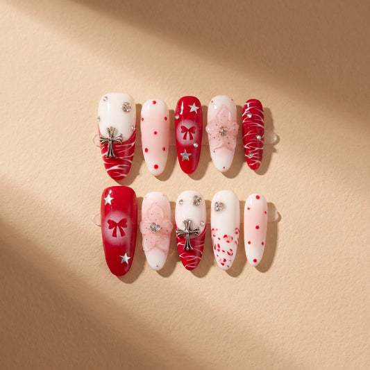 Scarlet Ritual 10-piece handmade press-on nail set with red bow and Christmas designs - product flat lay