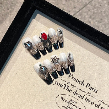 Serpent Blood Jewel 2098 long coffin press-on nail set with silver snakes, black tips and red jewel