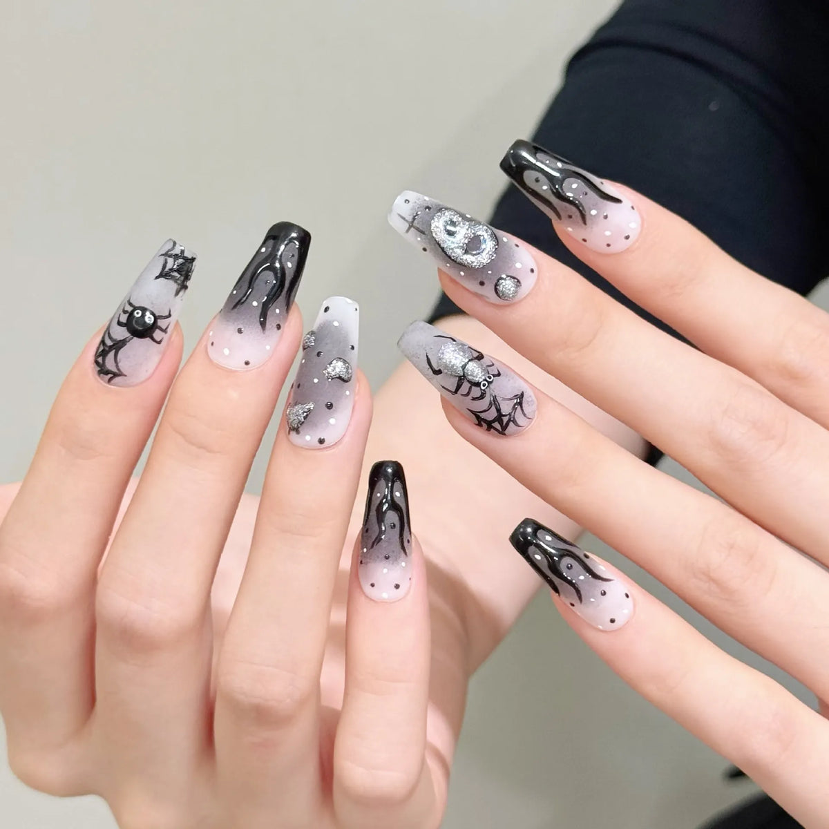 Silver Smoke gothic Halloween nails showing black fluid art, silver accents and hand-painted spiders