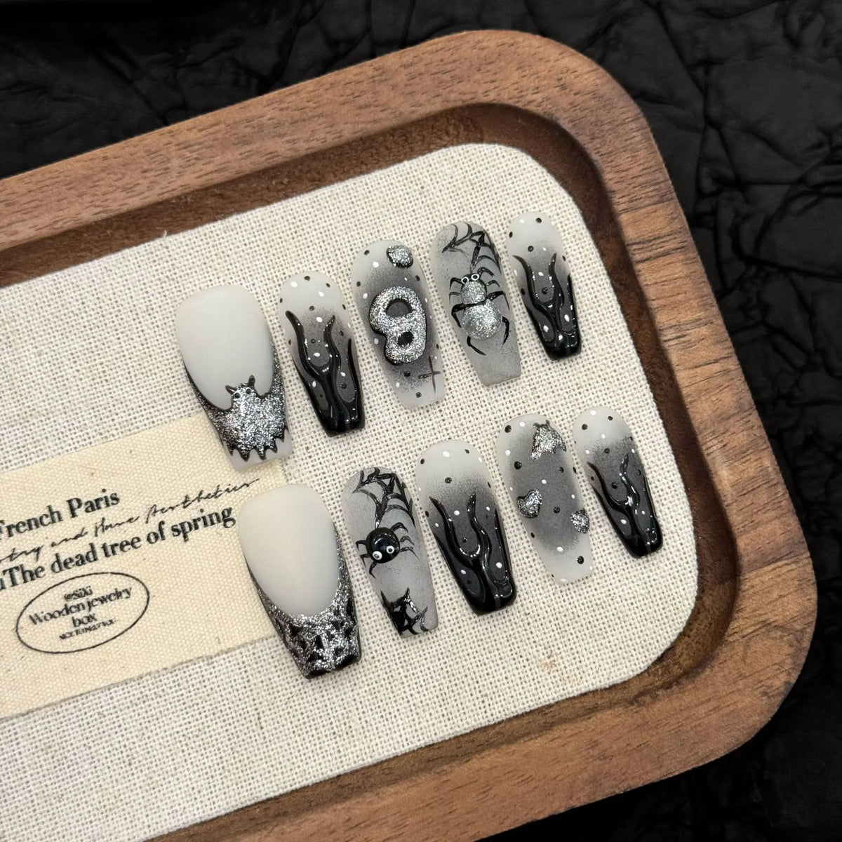 Silver Smoke 3033 medium coffin press-on nail set with black flowing lines, silver mirror art and spiders