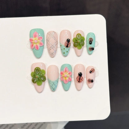 Summer Flower almond press-on nails with fresh 3D flower ladybug garden design on hand - lifestyle shot 🌸🐞