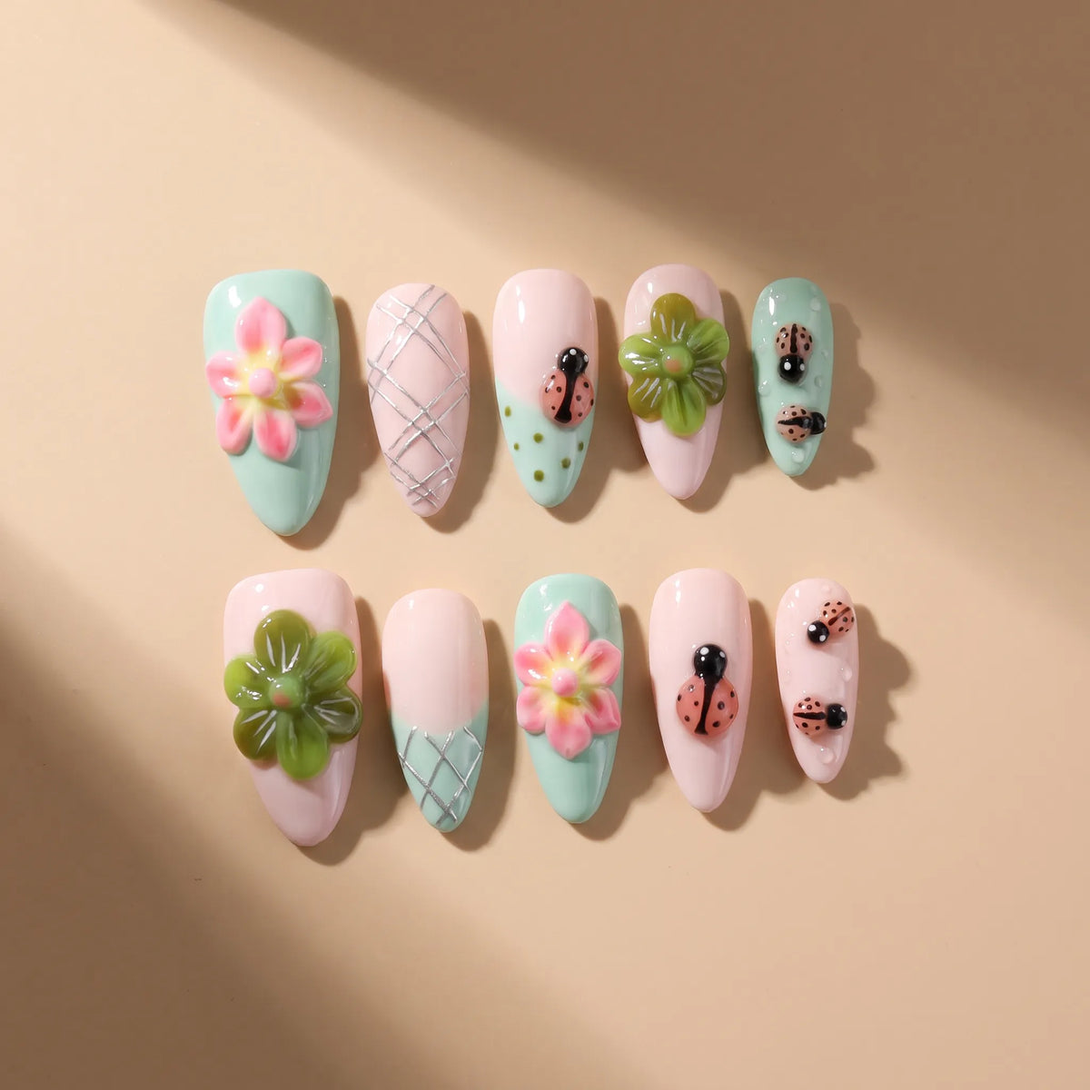 Summer Flower 10-piece handmade press-on nail set with 3D flower and ladybug designs - product flat lay 🐞