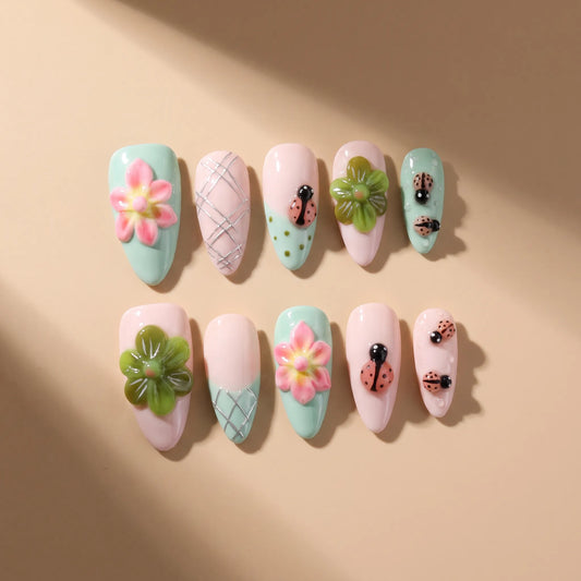 Summer Flower 10-piece handmade press-on nail set with 3D flower and ladybug designs - product flat lay 🐞