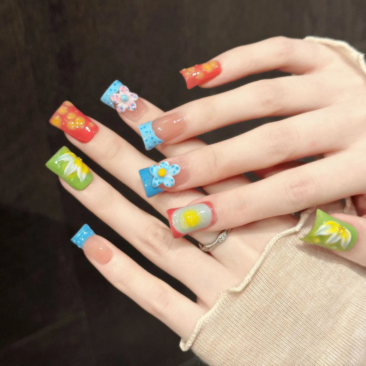 Sweet Fruit Garden almond nails angled view showing colorful fruit elements and 3D floral art
