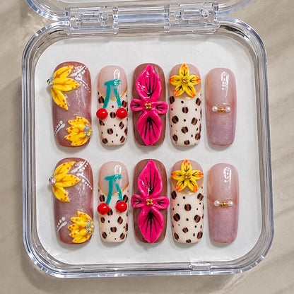Tropic Feline Bloom handmade Long Coffin nail set arranged in a clear presentation case