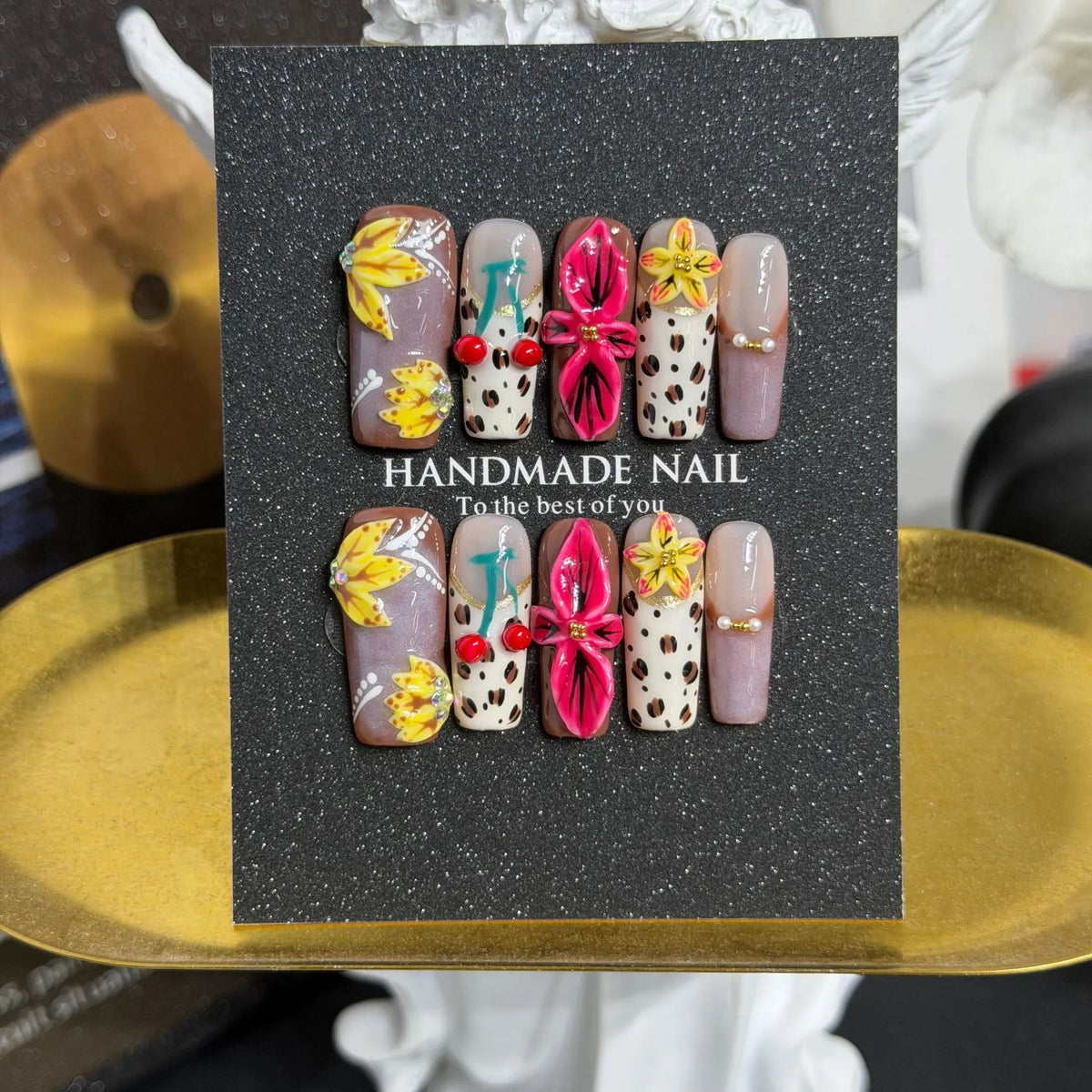 Lifestyle display of NM-A043 tropical floral and leopard Long Coffin press-on nails