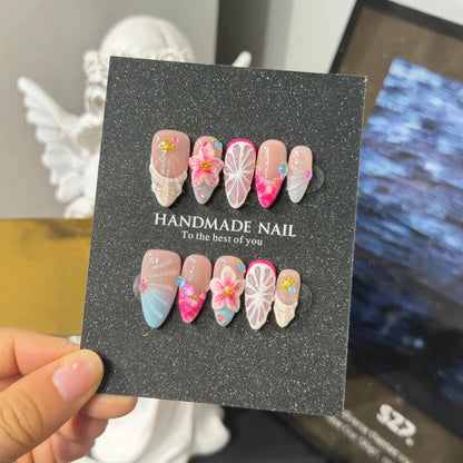Lifestyle display of pink blue and nude NM-C157 Medium Almond press-on nails