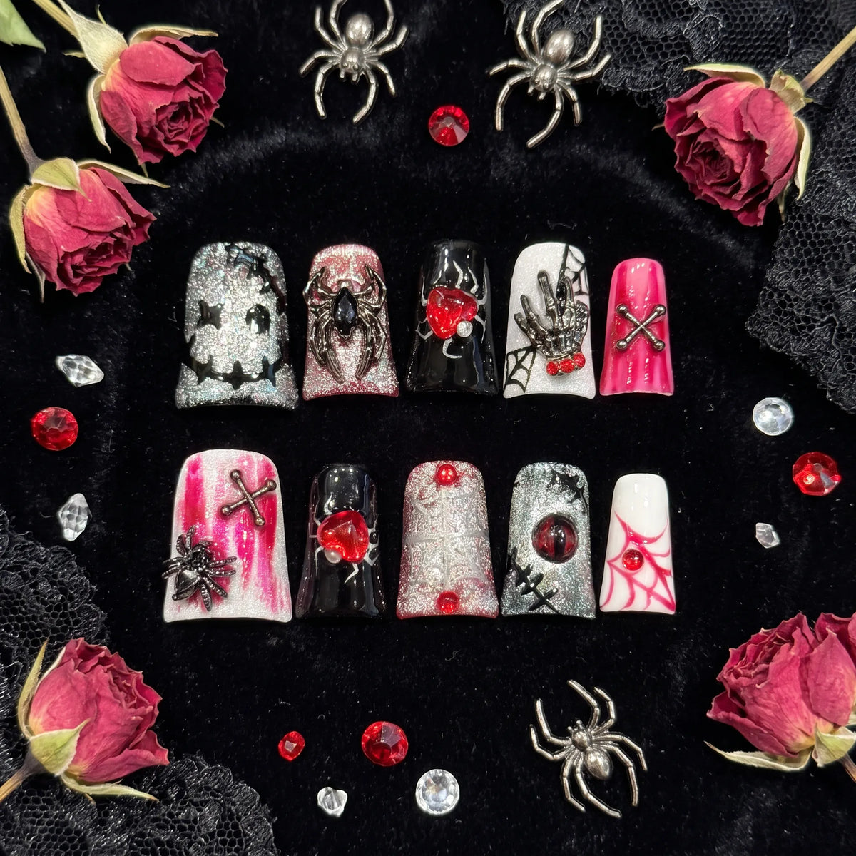 Web of Hearts coffin nails angled view showing silver glitter, black glossy finish, and 3D embellishments