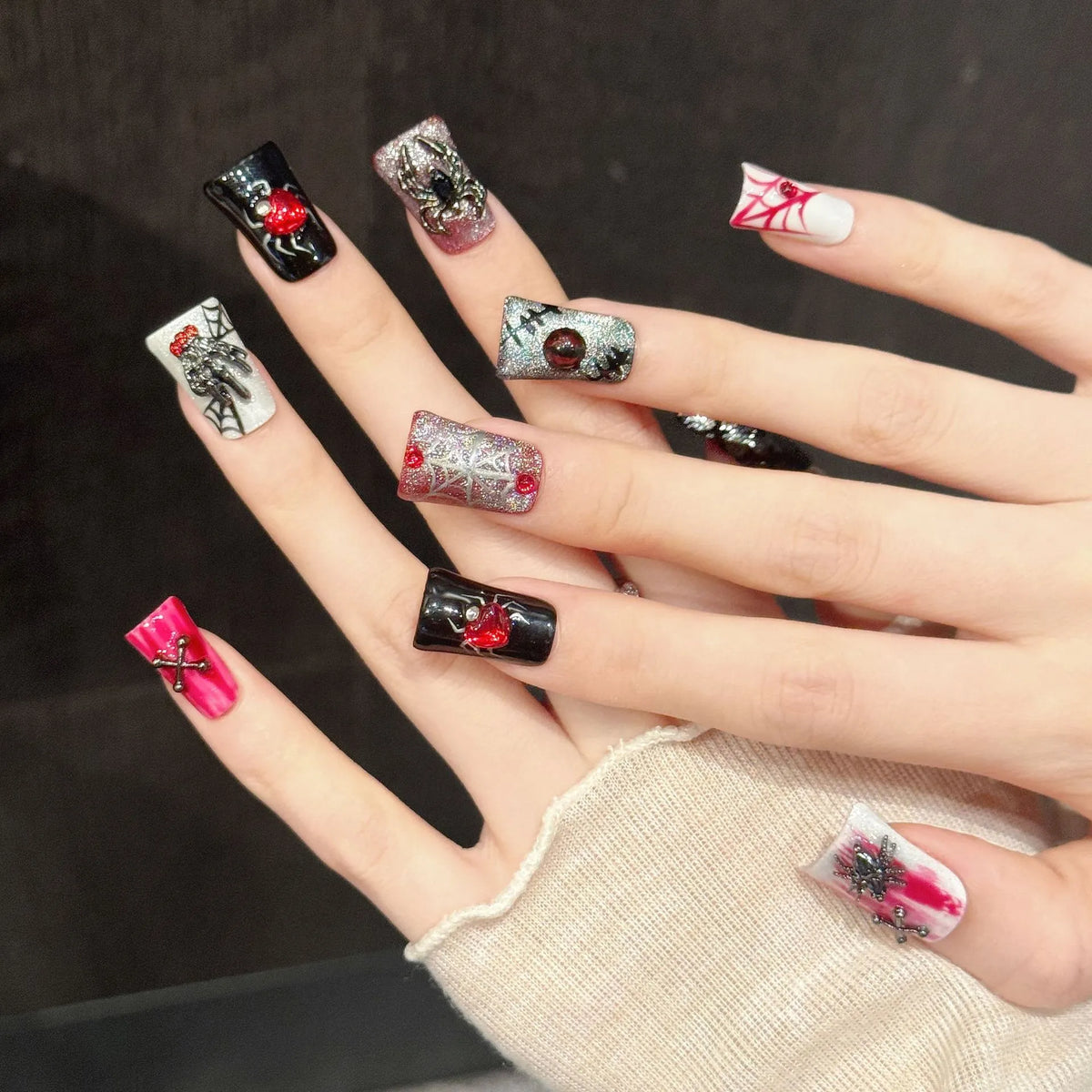 Web of Hearts short coffin press-on nails with gothic Halloween spider and rose design on hand - lifestyle shot